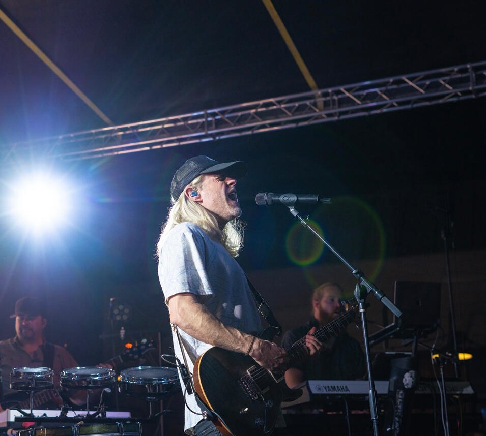 Guitarist on stage under concert lights